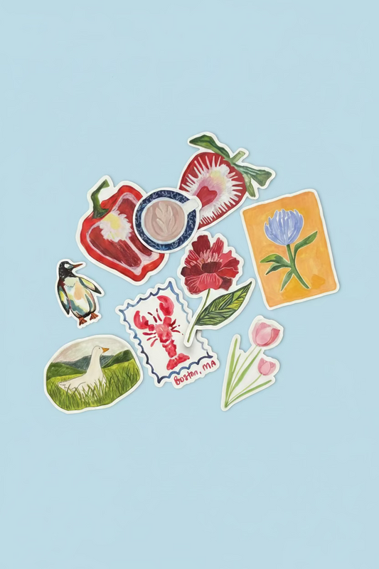A collection of colorful die-cut stickers featuring various illustrations, including flowers, a strawberry, a lobster, a fish, and a green leaf, arranged on a dark textured surface.